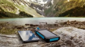 Featured | Battery solar energy device on the background of beautiful mountain scenery | Coolest Solar Powered Phone Chargers of the Future