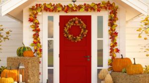 autumn decorated house with pumpkins and hay | Fall Wreath Ideas For Your Front Door | featured