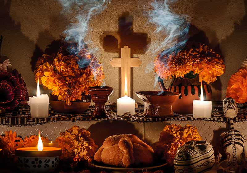 Traditional day of the dead altar with pan de muerto and candles
