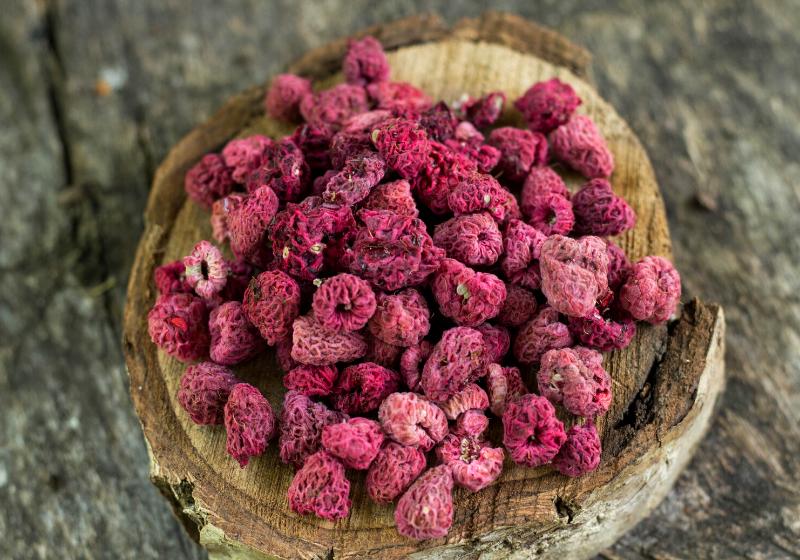 dry sun raspberry on wooden background | dehydrated snacks