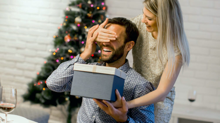 Young man getting present from loving woman for Christmas | Homemade Christmas Gifts Men Will Actually Love | creative diy christmas gifts | Featured
