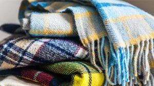 Stack of woolen checked blankets | DIY Warm Winter Blankets To Keep Away The Winter Chill | featured