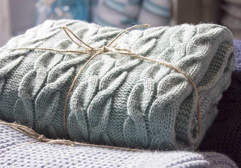 Warm knitted blankets folded stack | car survival kit