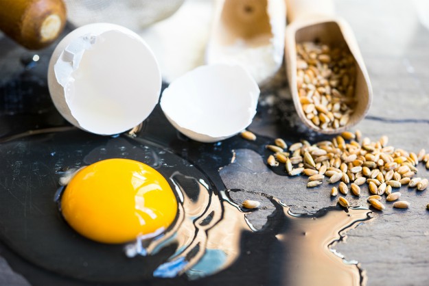 Ingredients for baking a bread, egg, wheat and flour on the dark cutting board  | Top 15 Ways to Use Eggshells on the Homestead