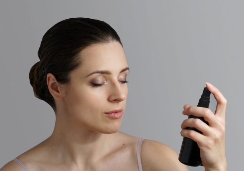 portrait brunette woman using spray black | glycerin oil