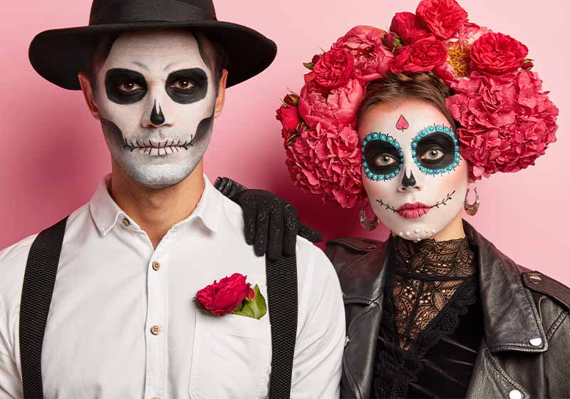 Serious woman and man have traditional mexican image, wear sugar skulls | scary costumes