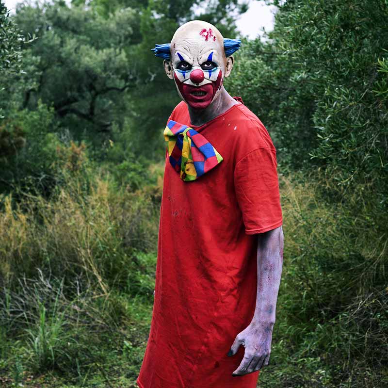 a scary evil clown wearing a dirty costume | scary costumes