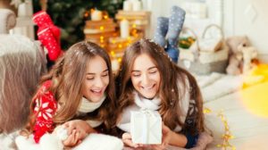 Beautiful young sisters twins teens. Christmas and New Year. Cosy holiday at the fireplace | Super Cool DIY Christmas Gifts For Teens | for teenage guys | Featured