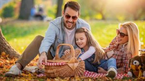 Happy family having picnic in park |Fall DIY Picnic Food Ideas And Crafts To Do This Weekend | featured