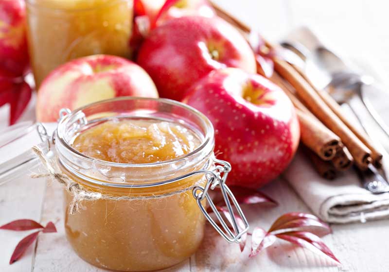 Homemade apple butter in glass jars with fresh apples and gift tags | crockpot recipes