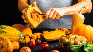 Woman peels and prepare pumpkin for cooking | House Favorite Pumpkin Recipes for Fall | featured
