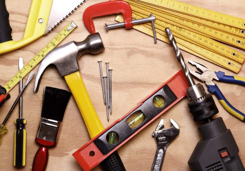 assorted work tools on wood | learn basic carpentry skills