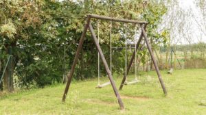 Swing In Backyard | How to Build a Wooden Swing Set That Your Kids Will Love | Featured