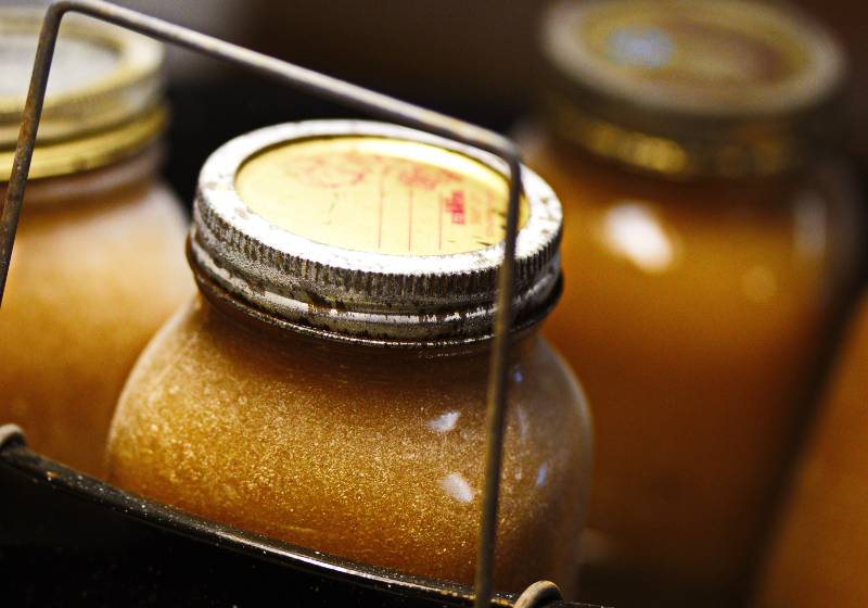 Golden applesauce preserved in glass mason jar | Use Mason Jars for Beekeeping