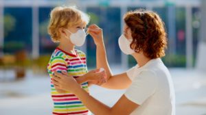 Mother and child wear facemask during coronavirus and flu outbreak | Pandemic Preparedness Guide For Homesteaders | Featured