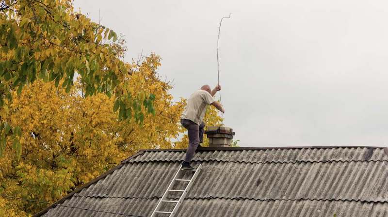 man sweeping the chimney | Homesteading Activities You Should Do This Spring | spring activities | spring break activities