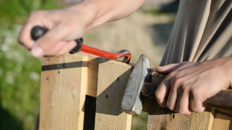 person fixing the fence | Homesteading Activities You Should Do This Spring | spring activities | spring outdoor activities