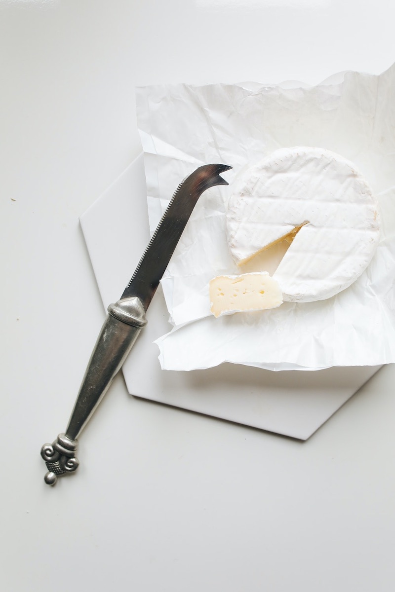 photo of knife near camembert cheese | mozzarella curd