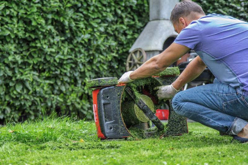 adult male using lawn mower | Lawn Mower Repair: Common Problems And How To Fix Them