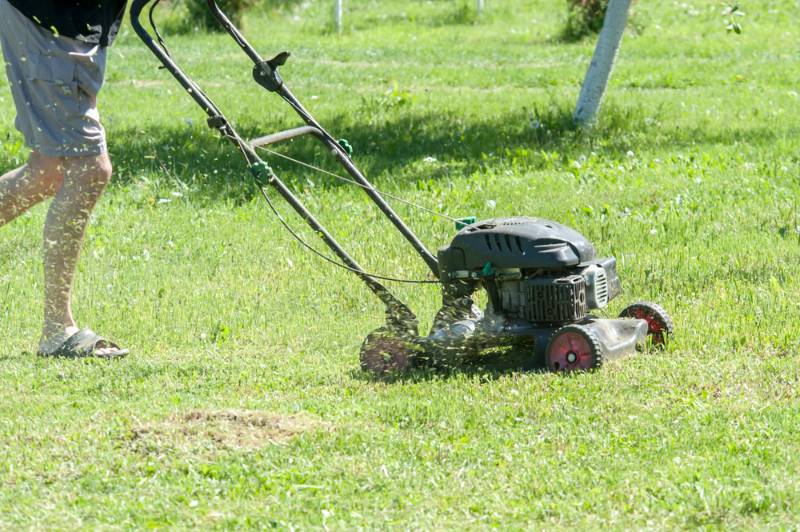 man using lawn mower | Lawn Mower Repair: Common Problems And How To Fix Them