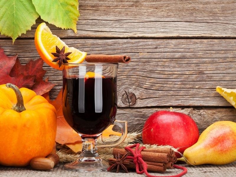 Autumn still life with mulled wine pumpkins apples pears | Halloween punch recipes