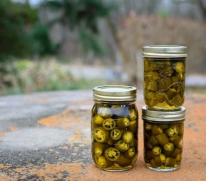 Canned jalapeno peppers in glass jar |