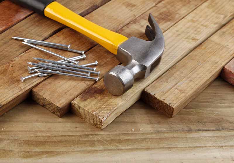Hammer and nails on wood | raising rabbits