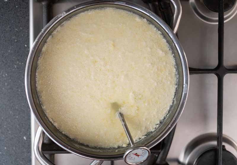 Milk being heated in a pan to make cheese | how to make cheese
