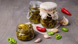 Pickled jalapeno slices in a glass jar | A Step By Step Guide To Canning Jalapenos |Featured