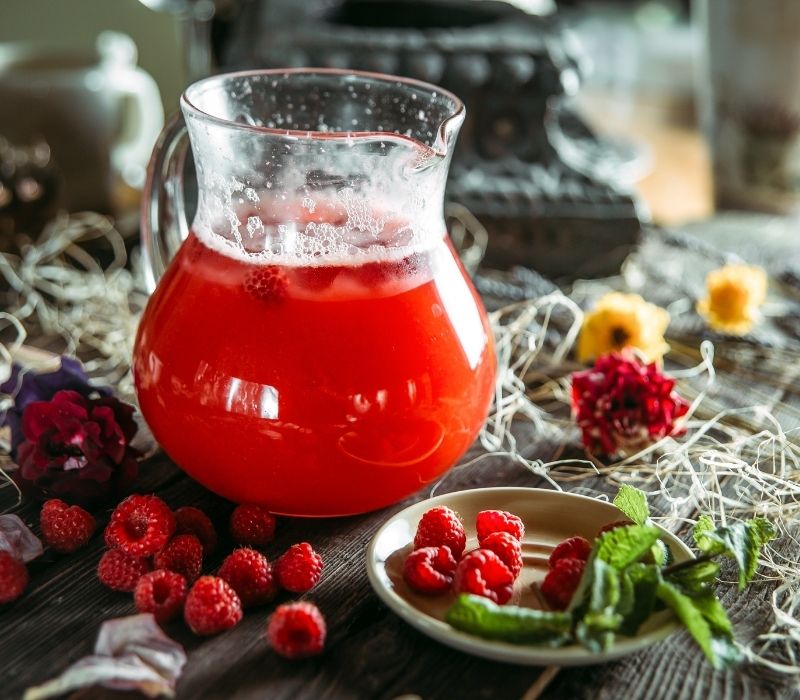 Sweet fresh berry lemonade beverage in a jar with raspberries | cocktail
