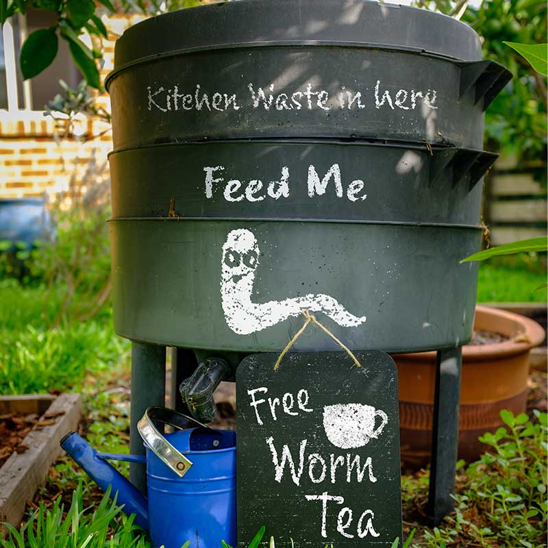 compost bin in organic garden with sign | vermicompost