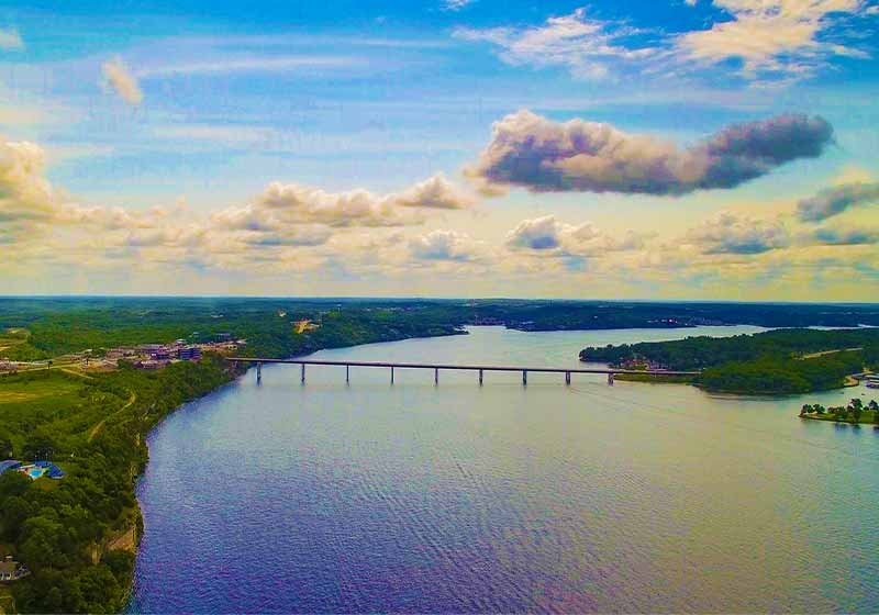 Aerial view of a bridge at the Lake of the Ozarks Missouri with a gorgeous blue sky | Beautiful Places to Visit This Fall
