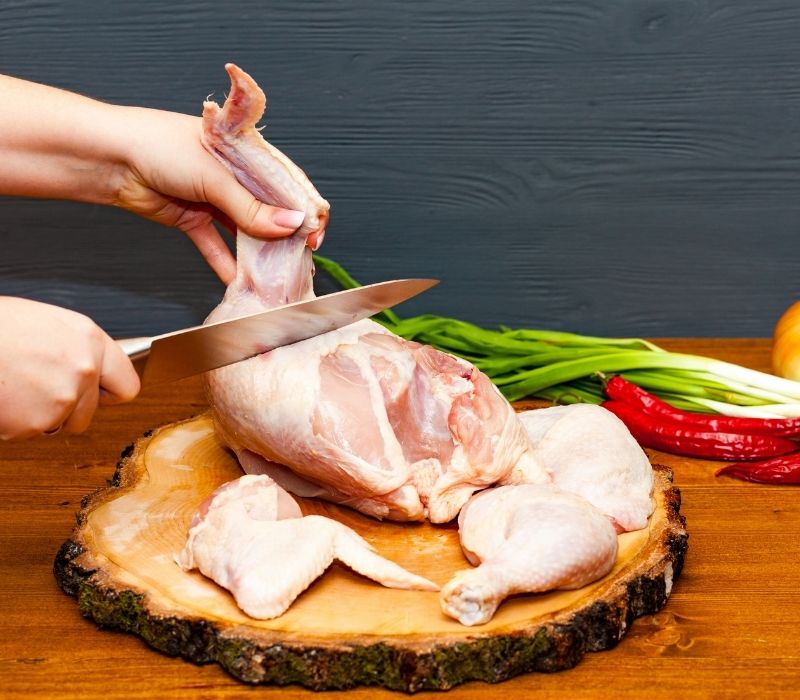 Cook chef hands woman cuts-carcass of whole chicken | chicken breast recipes
