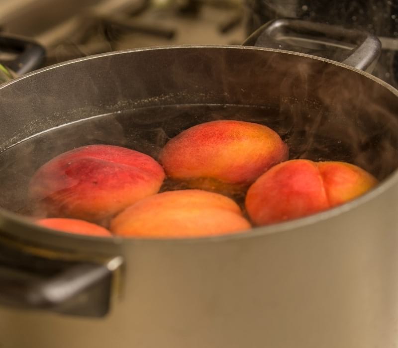 Peaches in a pot of boiling water | canning peaches