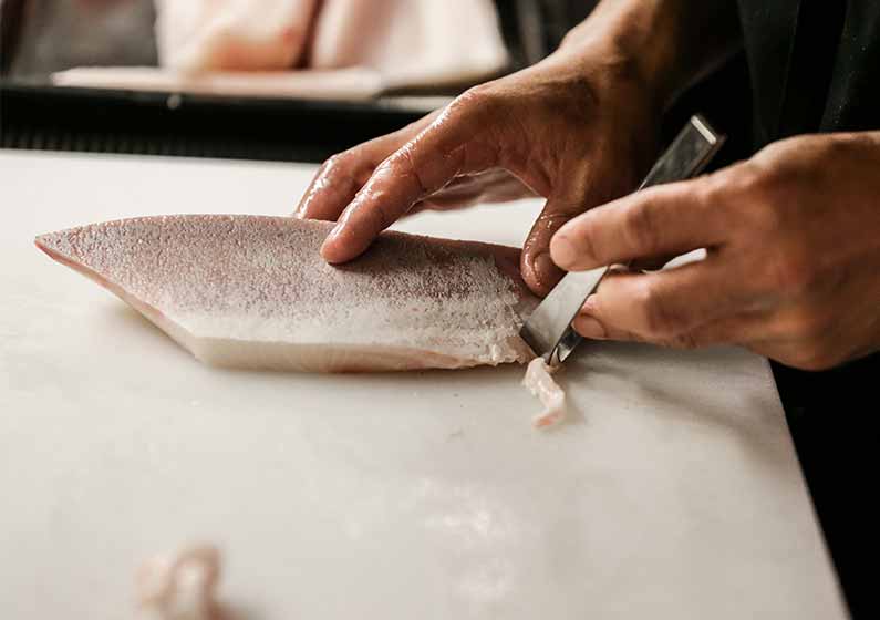 Scaling and removing bones from fillet of fish chef restaurant on white chopping board | how to fillet every fish