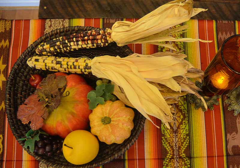 Thanksgiving Centerpiece with Indian Corn, pumpkins, apples, grapes, candles, wood bowl | thanksgiving centerpieces diy