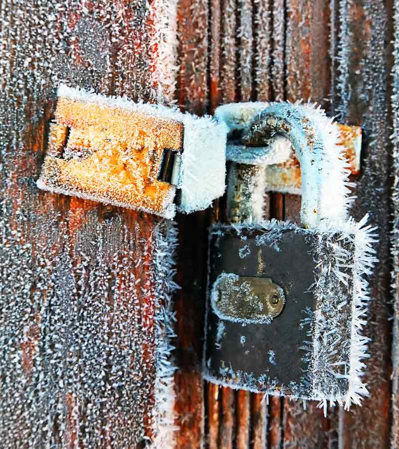 Frozen vintage lock of a wooden door | cold weather hacks 