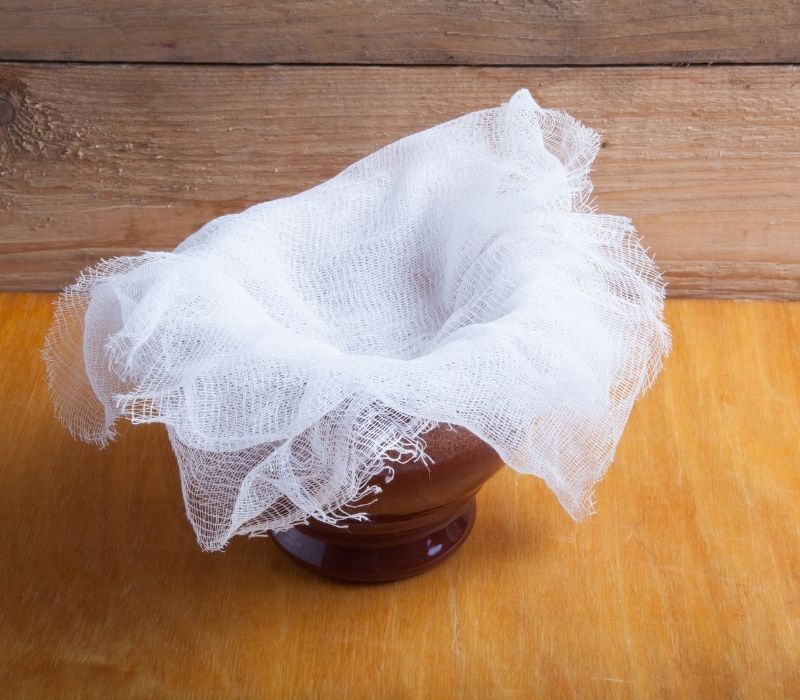 Cheesecloth on light wooden table Well water filtration system | walter filter 