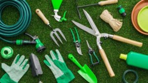 Gardening tools and utensils on a lush green meadow | | Feature