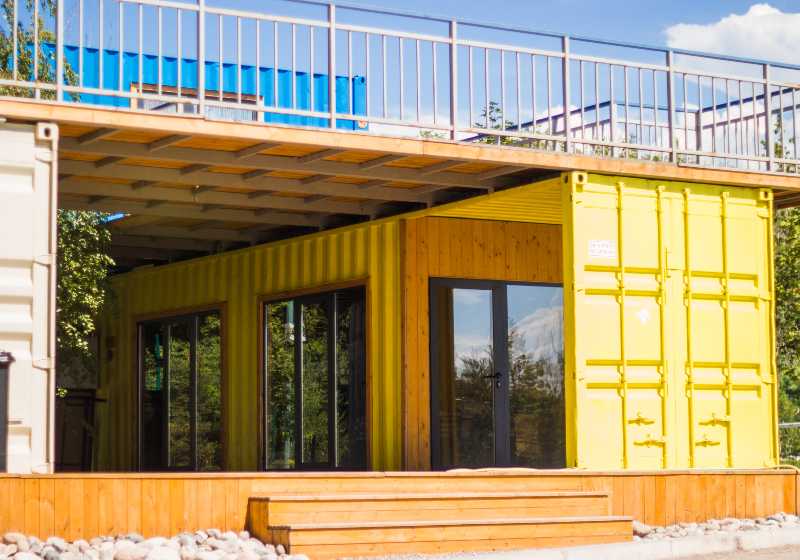 Modern metal building house made from shipping yellow containers on the beach | Modern Container Beach House