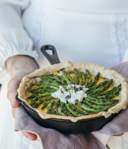 Asparagus Quiche person holding cooked food in cooking pan