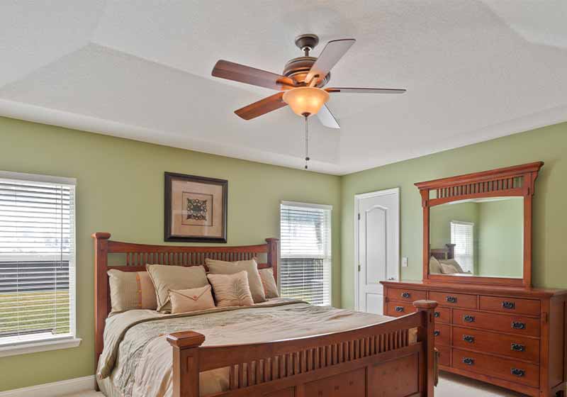 Bedroom in a nice home with a ceiling fan | snow day hacks