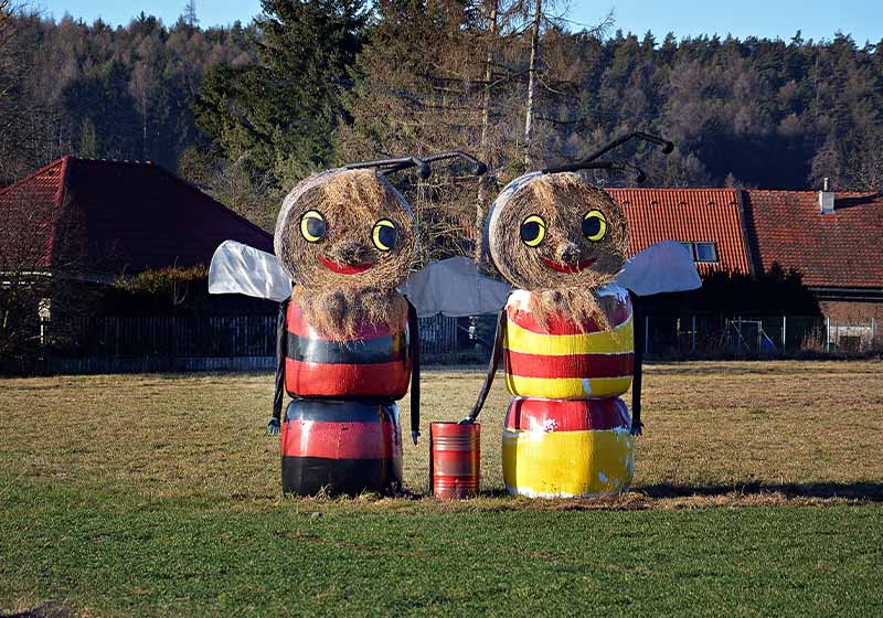 Figures of straw bales on a field | outdoor garden scarecrow