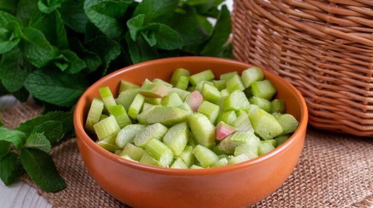 Frozen rhubarb in a plate on a white wooden table | How to freeze rhubarb | Featured