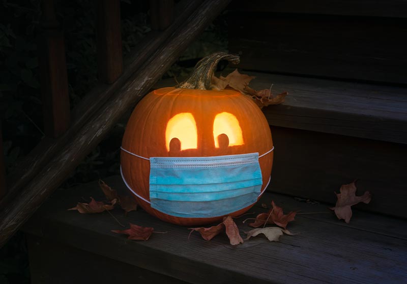 Lighted Carved Jack-o-Lantern dressed up for Halloweeen with COVID-19 Pandemic face mask | pumpkin carvings