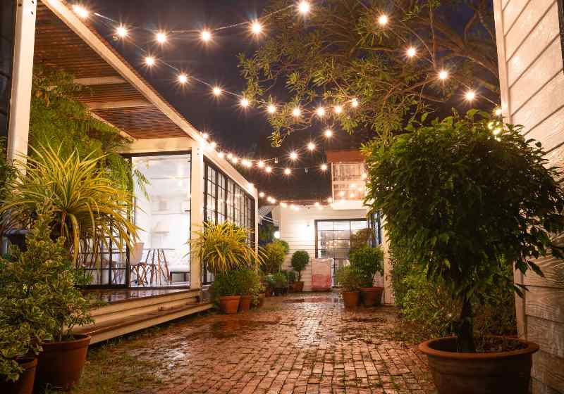 Modern metal White building made from shipping house containers at night | Alterra Glamping Shipping Container Home