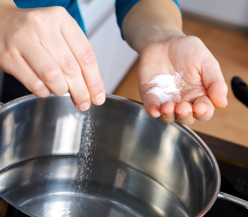 Woman salting water | lacto-fermented pickles