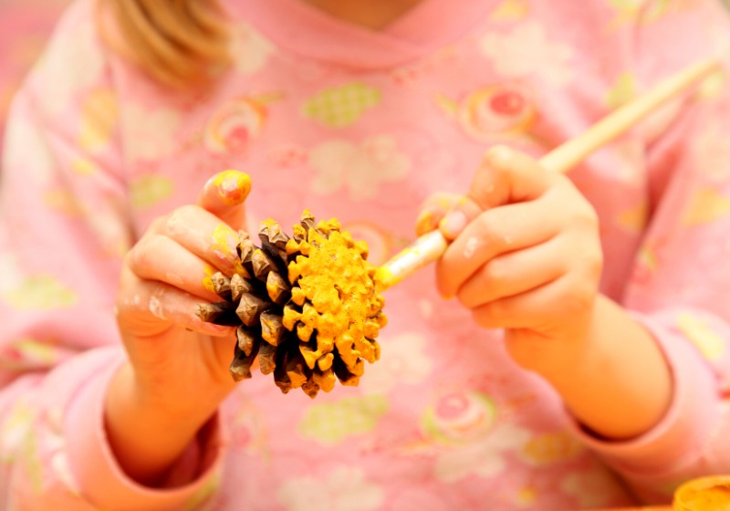 child painting pinecone yellow colour | paper easter crafts