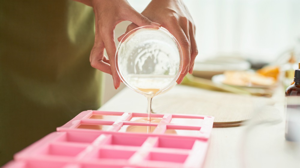 woman pouring soap mixture into plastic tray | Make Lye Free Soap On The Homestead | Homesteading | Lye Free Soap | soap making recipes free