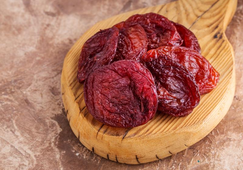 dried apricots on wooden board brown | best fruits and vegetables to dehydrate